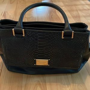 Tignanello black leather purse. 13x11 “. Abundance of compartments. Like new.